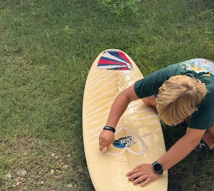 Passo la cera sulla mia tavola da surf sull’erba