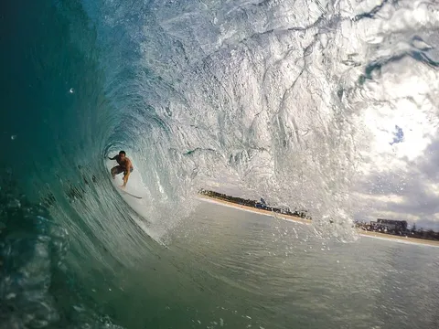Un surfista dentro il tubo di un’onda